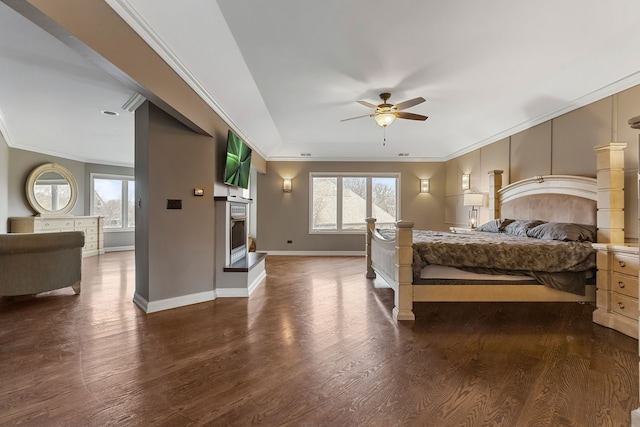 bedroom with ornamental molding, multiple windows, dark wood-type flooring, and ceiling fan