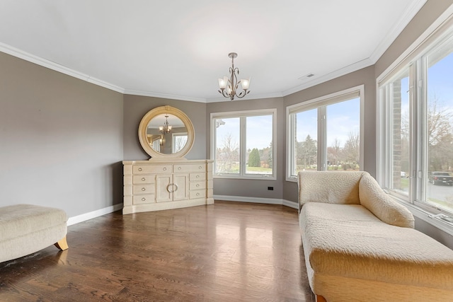 sitting room with a chandelier, dark hardwood / wood-style floors, plenty of natural light, and crown molding