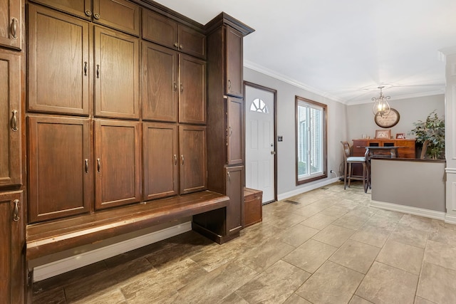 mudroom with ornamental molding and a chandelier