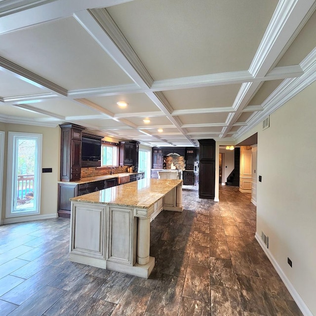 5N259 Wilton Croft Rd, Saint Charles, IL 60175 - kitchen featuring a center island, coffered ceiling, healthy amount of natural light, baseboards, and light stone counters