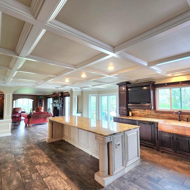 5N259 Wilton Croft Rd, Saint Charles, IL 60175 - kitchen featuring arched walkways, coffered ceiling, plenty of natural light, a sink, and a center island