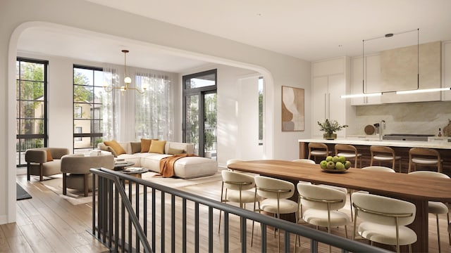 sitting room featuring light wood-type flooring and an inviting chandelier