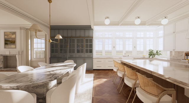 kitchen with white cabinets, dark parquet floors, decorative light fixtures, and a premium fireplace