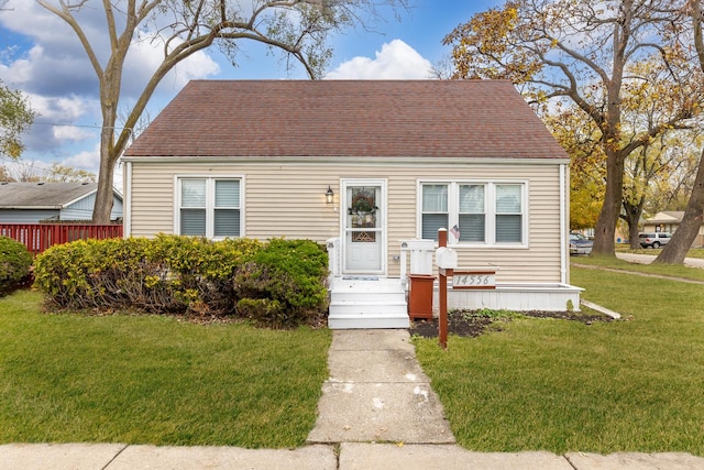 bungalow-style house featuring a front lawn