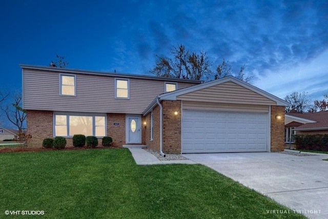 view of front of house with a yard and a garage