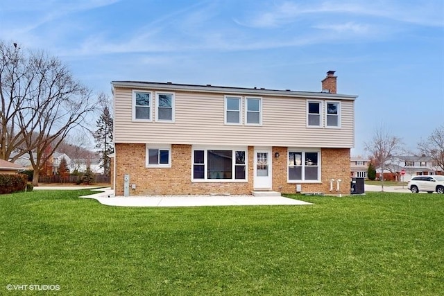 rear view of property featuring central AC and a yard