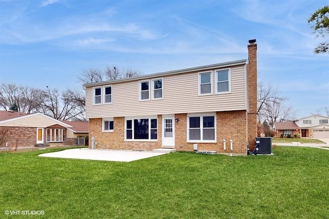 rear view of house featuring central air condition unit, a yard, and a patio