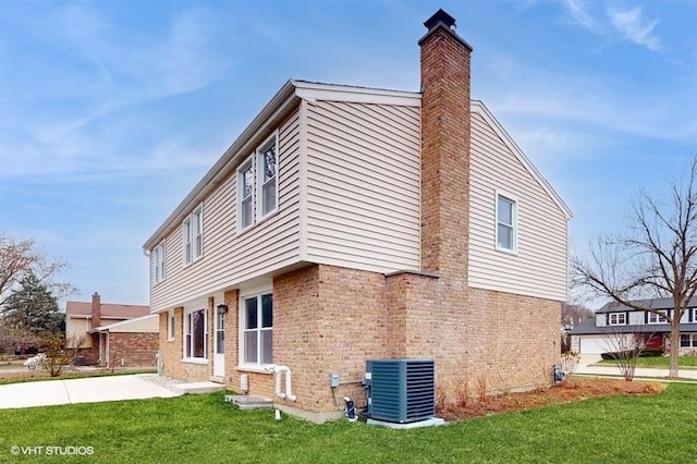 view of home's exterior with central air condition unit, a patio area, and a lawn