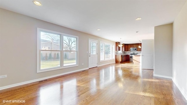 unfurnished living room featuring light hardwood / wood-style flooring