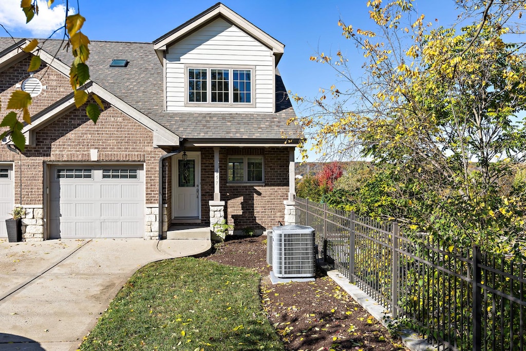 view of front of house featuring central air condition unit and a garage