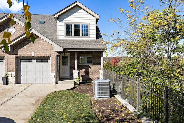 view of front of house featuring central air condition unit and a garage