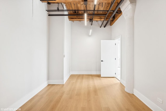 basement featuring light wood-style flooring and baseboards