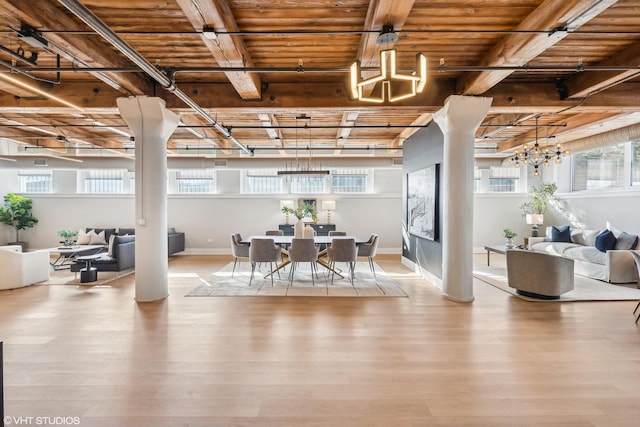 dining area featuring plenty of natural light, a notable chandelier, and light wood finished floors