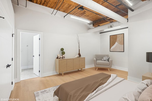 bedroom featuring light wood-style floors, visible vents, and baseboards