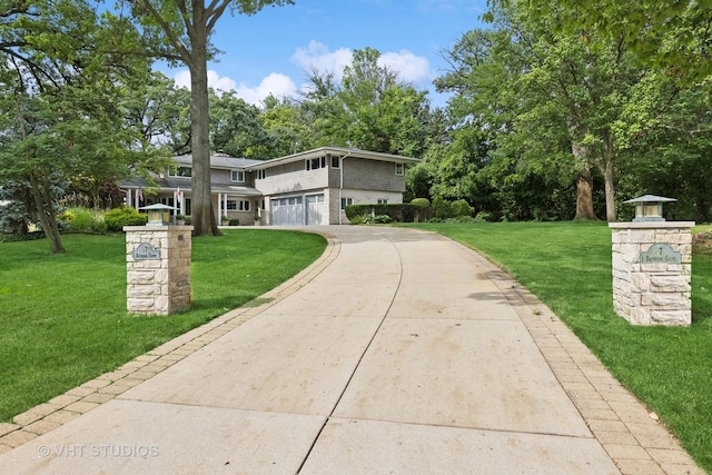 view of front of house with a garage and a front lawn