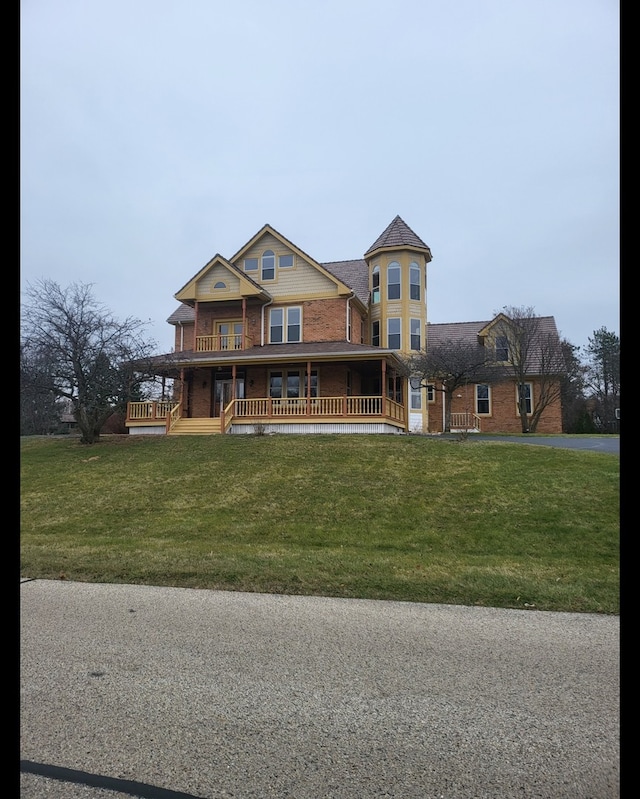 victorian home with a front yard and a porch