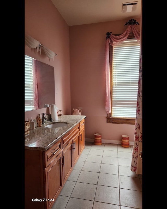 bathroom featuring tile patterned flooring and vanity