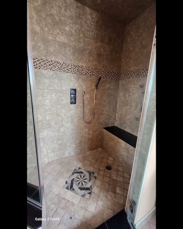 bathroom featuring tile patterned floors and tiled shower