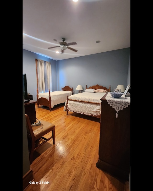 bedroom featuring ceiling fan and light hardwood / wood-style flooring