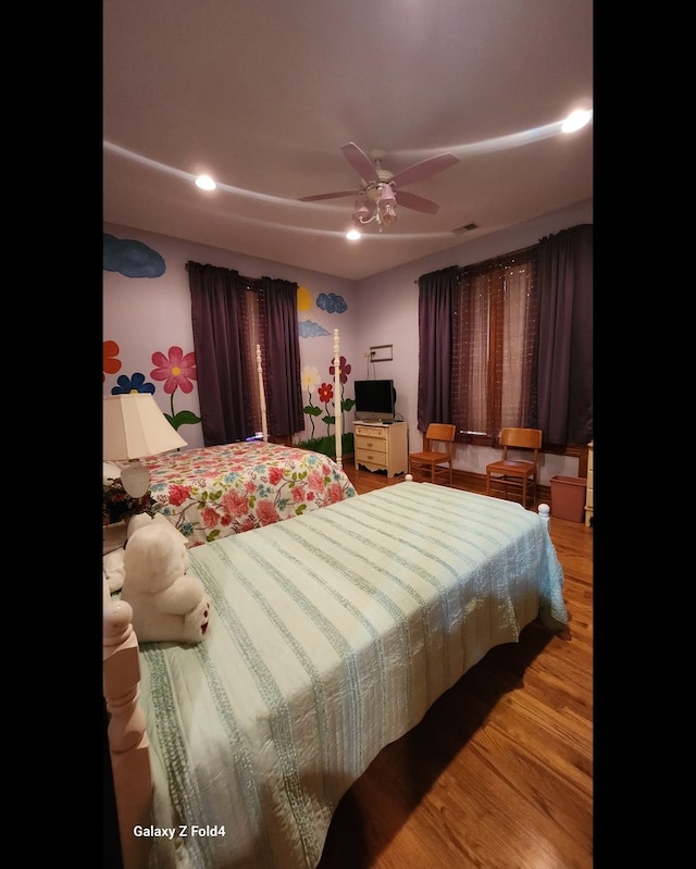 bedroom featuring hardwood / wood-style flooring and ceiling fan