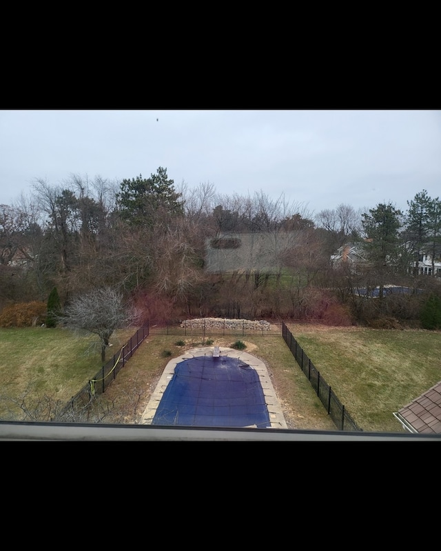 view of swimming pool with a lawn