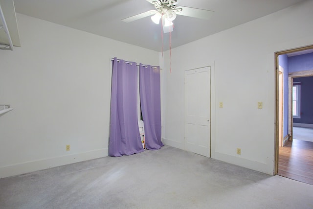 unfurnished bedroom featuring ceiling fan and light colored carpet