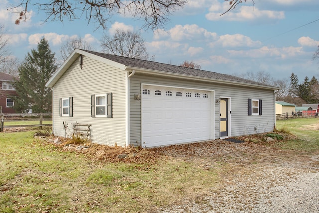 view of side of home with a garage and an outdoor structure