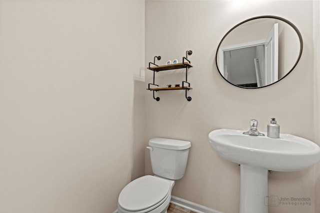 bathroom with wood-type flooring and toilet