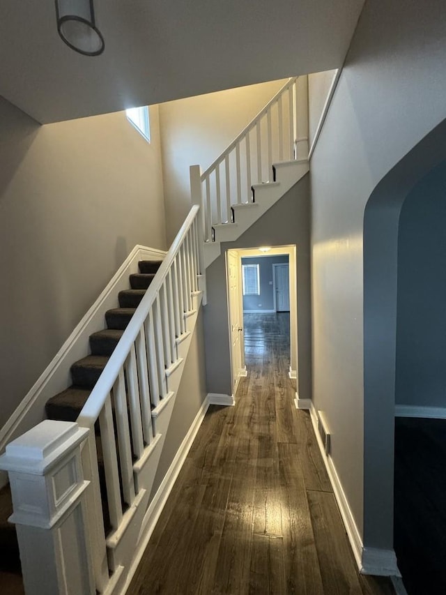 staircase with hardwood / wood-style floors