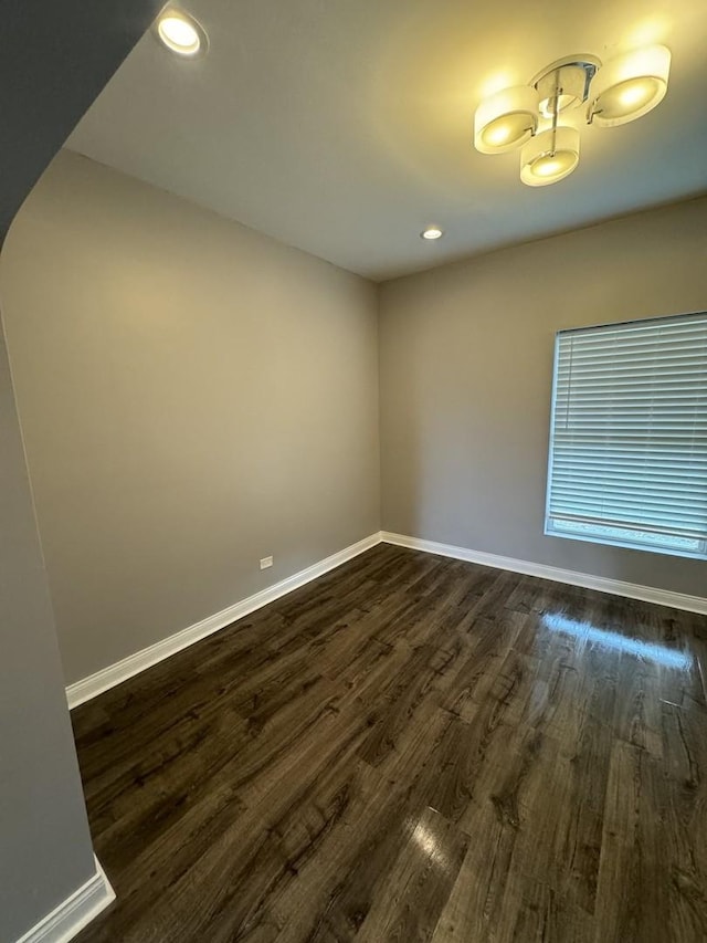 spare room with dark hardwood / wood-style floors