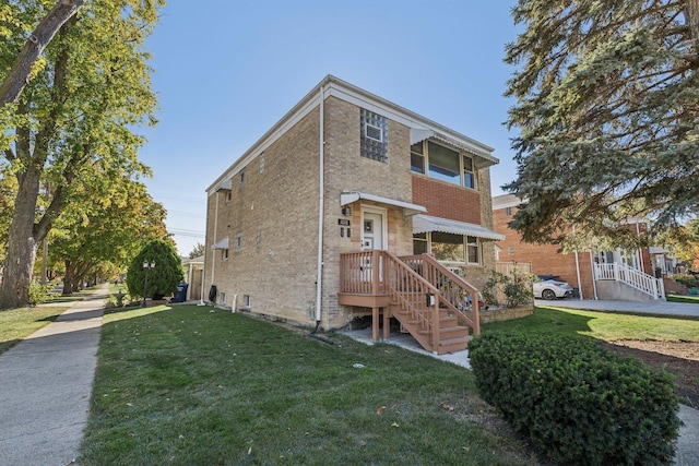 view of front of house with brick siding and a front yard