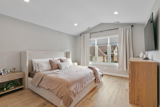 bedroom featuring vaulted ceiling and light hardwood / wood-style flooring