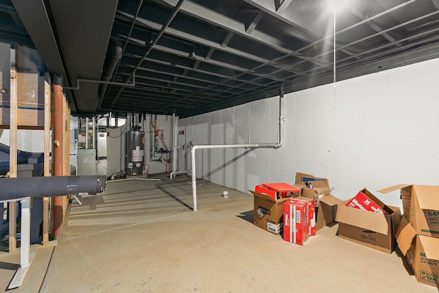 basement featuring gas water heater and heating unit