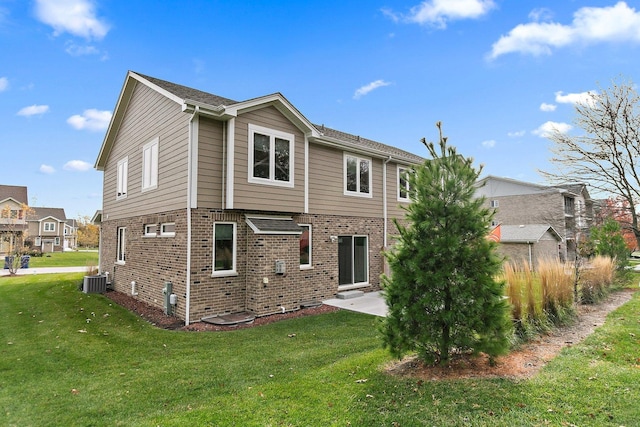 rear view of property featuring a lawn, a patio, and central AC unit