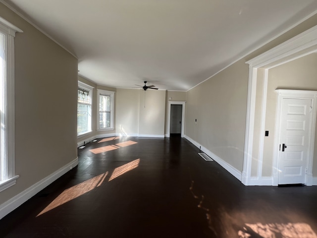 unfurnished room with ceiling fan, dark wood-type flooring, and ornamental molding