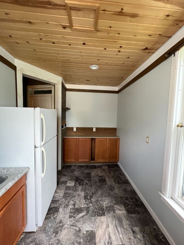 kitchen featuring white fridge, crown molding, and wooden ceiling