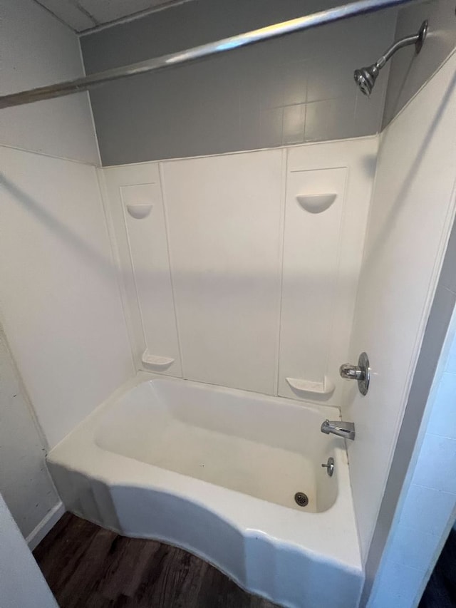 bathroom featuring hardwood / wood-style floors and tub / shower combination