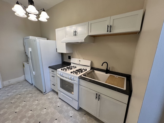 kitchen featuring white appliances, sink, decorative light fixtures, a notable chandelier, and white cabinetry