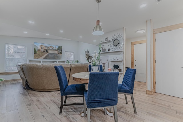 dining area featuring light hardwood / wood-style floors and vaulted ceiling