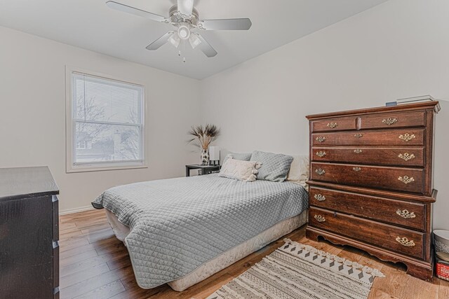 bedroom with ceiling fan and light wood-type flooring