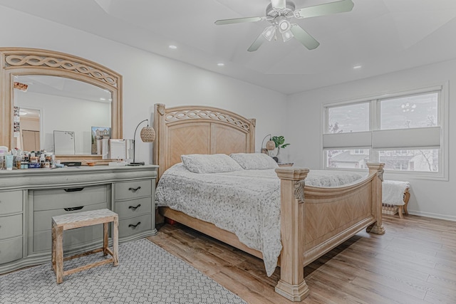 bedroom with ceiling fan and light hardwood / wood-style flooring