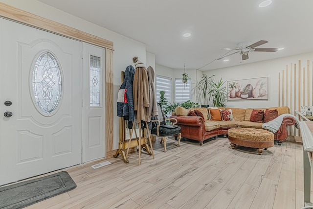 foyer with ceiling fan and light wood-type flooring