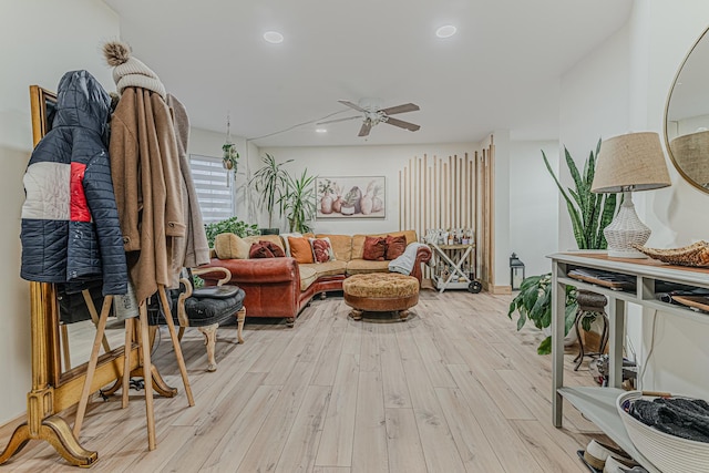 living room featuring ceiling fan and light hardwood / wood-style floors