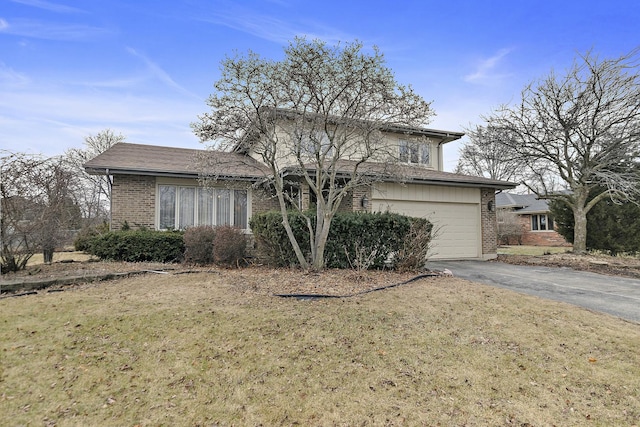 view of front of property featuring a garage and a front lawn