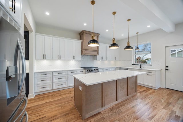 kitchen with white cabinets, stainless steel appliances, and a kitchen island