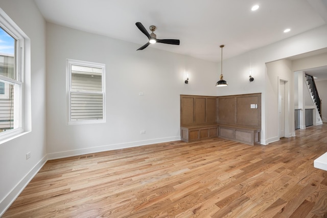 unfurnished living room with ceiling fan and light hardwood / wood-style floors