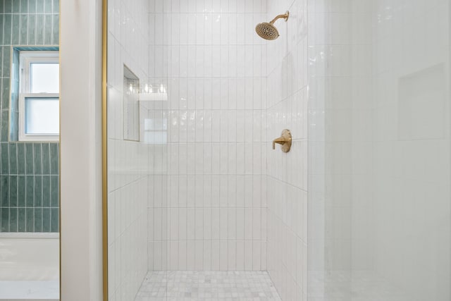 bathroom with tiled shower