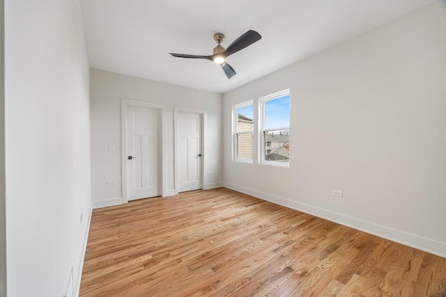 unfurnished bedroom with ceiling fan and light hardwood / wood-style flooring