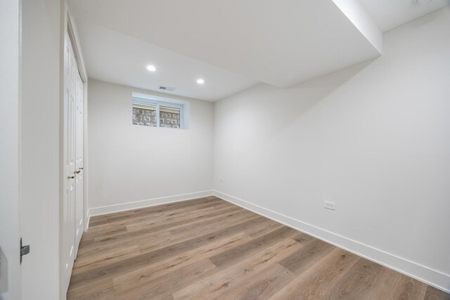 empty room with light hardwood / wood-style flooring