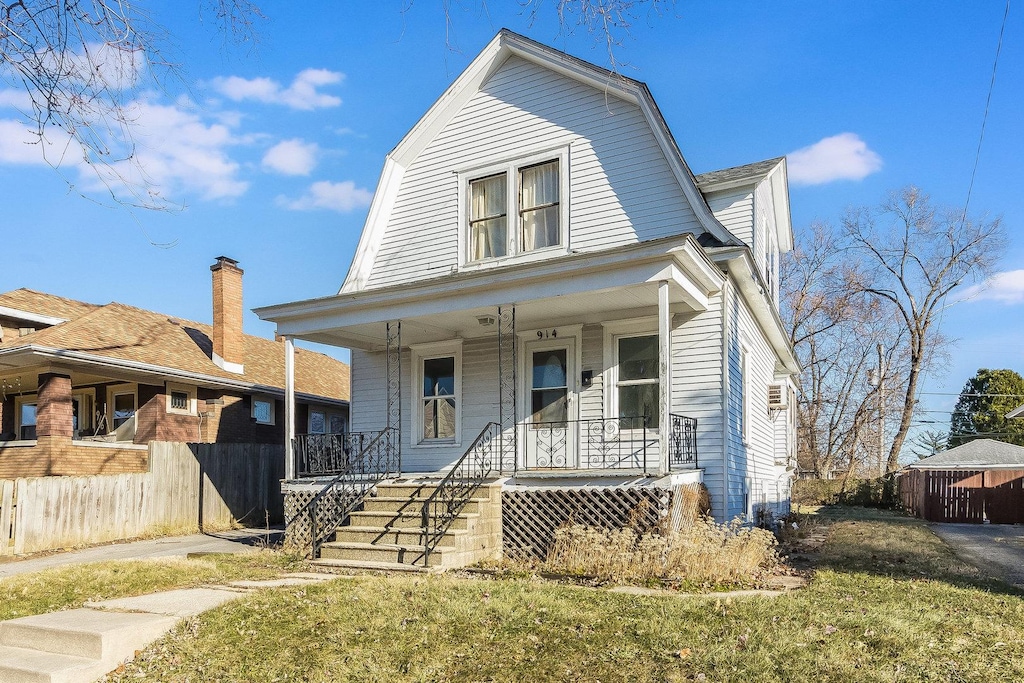 view of front of house with a front yard and a porch